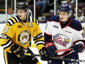 Sarnia Sting's Ryan McGregor, left, jockeys for position with Saginaw Spirit's Cole Perfetti at Progressive Auto Sales Arena in Sarnia, Ont., on Sunday, Oct. 28, 2018. Mark Malone/Chatham Daily News/Postmedia Network