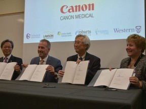 Schulich School of Medicine and Dentistry acting dean Dr. Davy Cheng, London Health Sciences Centre chief executive Paul Woods, Canon Medical Systems president and chief executive Toshio Takiguchi and St. Josephs Health Care London chief executive Dr. Gillian Kernaghan sign a major medical imaging partnership agreement Tuesday March 12, 2019.