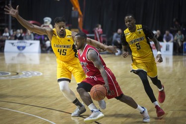 Windsor Express's Chris Jones drives past London Lightning's Marvin Phillips in National Basketball League of Canada action at the WFCU Centre, Wednesday. (DAX MELMER/Postmedia News)