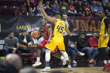 Windsor's Chris Jones is guarded closely along the sideline by London's Marvin Phillips in National Basketball League of Canada action between the Windsor Express and the London Lightning at the WFCU Centre, Wednesday. (DAX MELMER/Postmedia News)