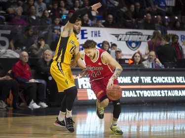 Windsor's Ryan Anderson tries to get past London's Garrett Williamson in National Basketball League of Canada action between the Windsor Express and the London Lightning at the WFCU Centre, Wednesday. (DAX MELMER/Postmedia News)