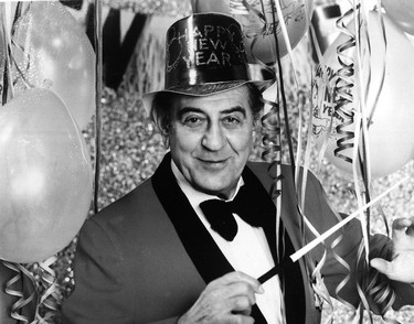 Bandleader Guy Lombardo poses with New Year's decorations in this 1976 file photo. The famed orchestra leader, whose rendition of "Auld Lang Syne" became a holiday mainstay, gave his final televised New Year's performance that year--a quarter century ago.  (London Free Press files)