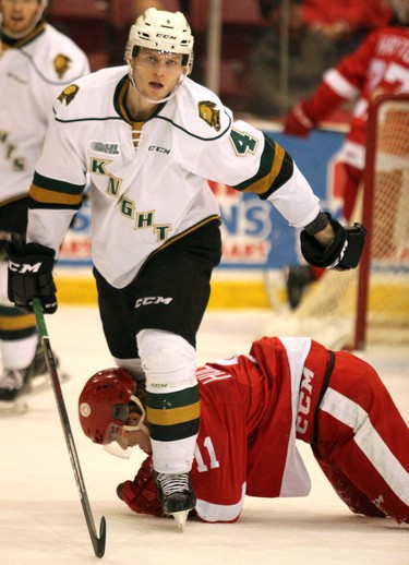 London Knights William Lochead steps over Soo Greyhouunds Mac Hollowell during first-period Ontario Hockey League action at GFL Memorial Gardens in Sault Ste. Marie, Ont., on Friday,March 15, 2019. (BRIAN KELLY/THE SAULT STAR/POSTMEDIA NETWORK)