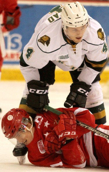 London Knights William Lochead steps over Soo Greyhouunds Mac Hollowell during first-period Ontario Hockey League action at GFL Memorial Gardens in Sault Ste. Marie, Ont., on Friday,March 15, 2019. (BRIAN KELLY/THE SAULT STAR/POSTMEDIA NETWORK)