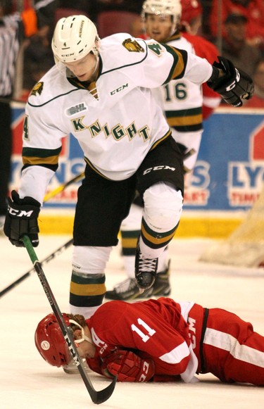 London Knights William Lochead steps over Soo Greyhouunds Mac Hollowell during first-period Ontario Hockey League action at GFL Memorial Gardens in Sault Ste. Marie, Ont., on Friday,March 15, 2019. (BRIAN KELLY/THE SAULT STAR/POSTMEDIA NETWORK)