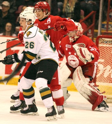 Soo Greyhounds Mac Hollowell defends against London Knights Josh Nelson during first-period Ontario Hockey League action at GFL Memorial Gardens in Sault Ste. Marie, Ont., on Friday,March 15, 2019. Goalie Matthew Villalta is at right. (BRIAN KELLY/THE SAULT STAR/POSTMEDIA NETWORK)
