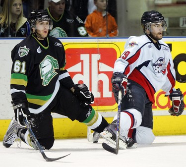 John Tavares of the London Knights and Conor O'Donnell of the Windsor Spitfires wait for an official to untie them after their skates and laces became entangled during the first period of last night's game at the John Labatt Centre. (2009)