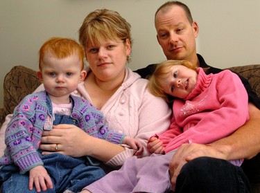 Kimberley Vander Schelde holds her 18-month-old daughter Olivia, while Sam Vander Schelde cuddles with four-year-old Holland. Olivia would have been undergoing life-saving surgery for a brain tumour yesterday had the operating room at Children's Hospital of Western Ontario been open. (2006 File photo)