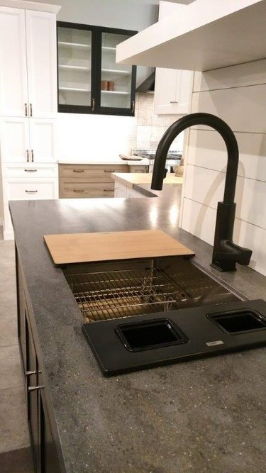 Corian countertop with Blanco sink and Moen faucet with a shiplap wall treatment.