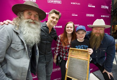 The members of the Washboard Union, David Roberts, Aaron Grain and Chris Duncombe, pose with Tiffany Almeida and Noah Almeida at the Juno Fan Fare at Masonville Place mall in London, Ont. Long lines of fans were on hand to be photographed with nominees such as Loud Luxury, Killy, the Reklaws and the Washboard Union. Photograph taken on Saturday March 16, 2019. 
Mike Hensen/The London Free Press/Postmedia Network