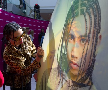 Killy (Khalil Tatem) signs a huge poster of himself at the Juno Fan Fare at Masonville place mall in London, Ont. Long lines of fans were on hand to be photographed with nominees such as Loud Luxury, Killy, the Reklaws and the Washboard Union.
Photograph taken on Saturday March 16, 2019. Mike Hensen/The London Free Press/Postmedia Network