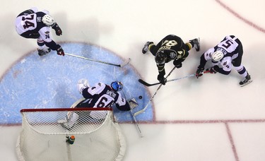 JJ Piccinich of the Knights works in tight on Michael DiPietro of the Spitfires while being checked by Austin McEneny of the Spits while Sean Day covers the slot during the first period of their playoff game at Budweiser Gardens on Friday March 24, 2017.  Mike Hensen/The London Free Press/Postmedia Network