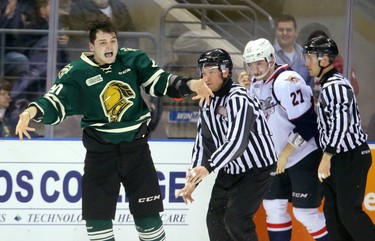 Adrian Carbonara of the Knights exhorts his team after a fight with Hayden McCool of the Spitfires during the first period of their 2nd playoff game Sunday March 26, 2017 at Budweiser Gardens. Mike Hensen/The London Free Press/Postmedia Network