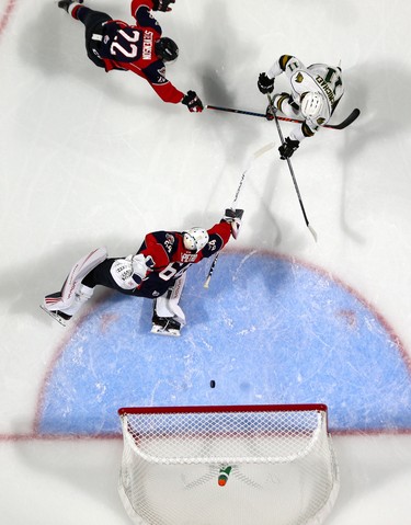 Conner McMichael of the Knights opens their season with the first goal on a rebound off of Windsor Spitfire goalie Michael DiPietro, with Thomas Stevenson too far away to make a play. Budweiser Gardens on Friday September 21, 2018.  Mike Hensen/The London Free Press/Postmedia Network