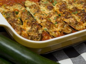 Stuffed zucchini and eggplant is roasted in tomato sauce which is spooned over the vegetables at serving. (Derek Ruttan/The London Free Press)