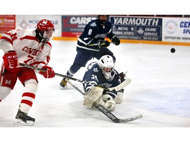 Medway's Mark Cassidy flips a shot over CCH goalie Brennan Panziera and over the net during their WOSSAA AAA gold medal game at Joe Thornton Community Centre in St. Thomas on Tuesday March 5, 2019.  The Cowboys rode to a 2-0 win for the gold and will move on to OFSAA in Barrie. Mike Hensen/The London Free Press/Postmedia Network