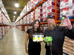Cathy Siskind-Kelly and Rob Kelly, co-founders of London's Black Fly Beverage Co., show off their cavernous new 60,000 sq. ft plant that they are already filling  with their ready-to-drink spirit beverages.  Kelly holds their newest product, a shaker-style tequila shot. (Mike Hensen / The London Free Press)