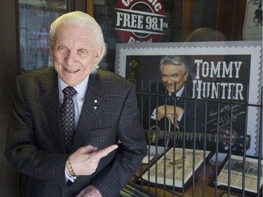 Tommy Hunter outside of the London Music Hall of Fame that has a large print of a postage stamp featuring his image in its window in London, Ont. on Friday March 8, 2019. (Derek Ruttan/The London Free Press)