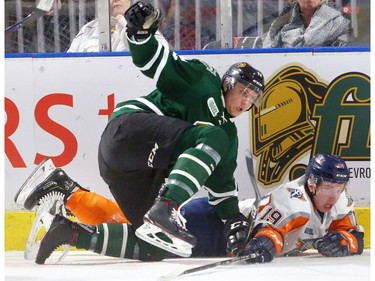 Knights defenceman Alex Regula covers Kyle Harris of the Flint Firebirds behind the London net during the first period at Budweiser Gardens Friday. (MIKE HENSEN, The London Free Press)