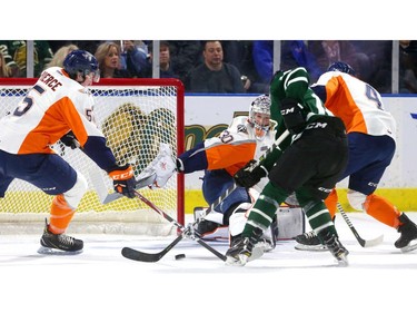 Luke Evangelista of the Knights tries to corral a rebound in front of Emanuel Vella of the  Flint Firebirds while being checked by Hakon Nilsen with Emmet Pierce coming in to help for Flint during the first period at Budweiser Gardens Friday. (MIKE HENSEN, The London Free Press)