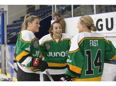 Canadian national women's hockey team members Natalie Spooner, left, Sarah Nurse and Renata Fast chat during a pre-scrimmage warm-up in preparation for the Juno Cup on Thursday March 14, 2019 in London. The Juno Cup is an annual celebrity fundraising hockey game in support of MusiCounts, Canada's music education charity. The game, featuring musicians, former NHL players and members of the national women's hockey team, will take place Friday, March 15 at the Western Fair Sports Centre. (Derek Ruttan/The London Free Press)