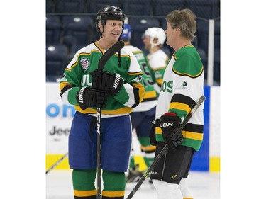 Former Calgary Flame and Toronto Maple Leaf  Gary Roberts, left, speaks with Blue Rodeo frontman Jim Cuddy  during a pre-scrimmage warm up in preparation for the Juno Cup on Thursday March 14, 2019 in London. The Juno Cup is an annual celebrity fundraising hockey game in support of MusiCounts, Canada's music education charity. The game, featuring musicians, former NHL players and members of the national women's hockey team, will take place Friday, March 15 at the Western Fair Sports Centre. (Derek Ruttan/The London Free Press)