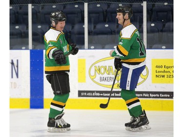 Former Montreal Canadien and Edmonton Oiler Mark Napier, left, talks with former Calgary Flame and Toronto Maple Leaf  Gary Roberts during a pre-scrimmage warm up in preparation for the Juno Cup on Thursday March 14, 2019 in London. The Juno Cup is an annual celebrity fundraising hockey game in support of MusiCounts, Canada's music education charity. The game, featuring musicians, former NHL players and members of the national women's hockey team, will take place Friday, March 15 at the Western Fair Sports Centre. (Derek Ruttan/The London Free Press)