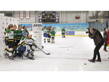 Female Juno Cup players have their picture taken by official photographer of the Junos Alex Urosevic during a pre-scrimmage warm-up on Thursday March 14, 2019 in London. The Juno Cup is an annual celebrity fundraising hockey game in support of MusiCounts, Canada's music education charity. The game, featuring musicians, former NHL players and members of the national women's hockey team, will take place Friday, March 15 at the Western Fair Sports Centre. (Derek Ruttan/The London Free Press)