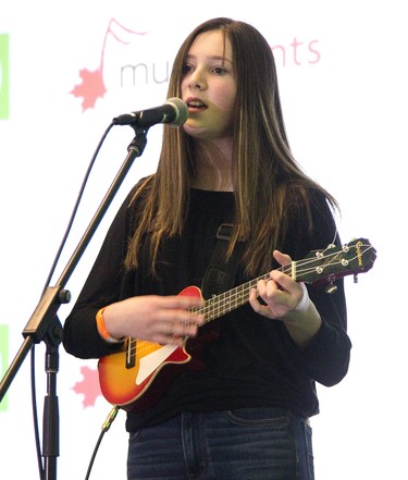 Madison Schofield,13, of the London Girls Rock Camp performs a song she wrote called 4 AM while playing ukulele during the opening of  TD Green Room at the Doubletree Hilton in London on Friday. (Derek Ruttan/The London Free Press)