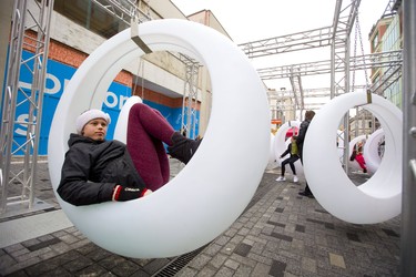 Ania Magier, 11, reclines in a hanging chair on Dundas Place,  between Richmond and Talbot streets, in downtown London on Friday. (Mike Hensen/The London Free Press)
