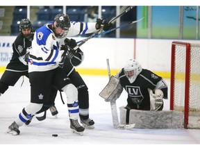 Cohen Kiteley of the Nationals is tied up by Gianluca Pizzuto of the Vipers in front of the LaSalle goalie Will Tragge during Game 5 of their GOJHL Western Conference semifinal at Western Fair Sports Centre on Wednesday night. (MIKE HENSEN, The London Free Press)