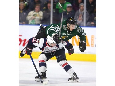 Nathan Staios of the Windsor Spitfires backs into Matvey Guskov of the London Knights who comes over his back in the first period of their playoff game at Budweiser Gardens in London on Friday. (Mike Hensen/The London Free Press)