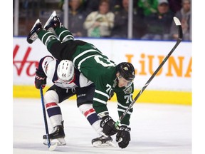 Nathan Staios of the Windsor Spitfires backs into Matvey Guskov of the London Knights who comes over his back in the first period of their playoff game at Budweiser Gardens in London on Friday. (Mike Hensen/The London Free Press)