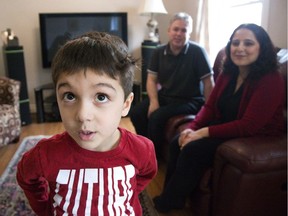 Four-year-old Alexander Lock needs ABA therapy. He is pictured with his parents Bryan and Neda Lock in London on Sunday. (Derek Ruttan/The London Free Press)