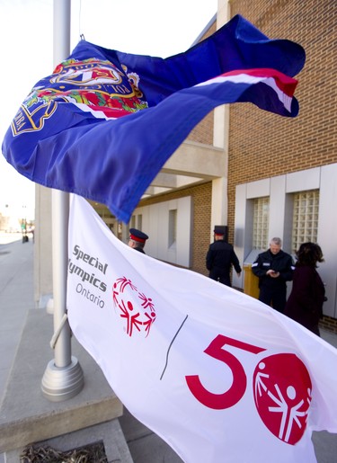 London police get ready to raise the 50th anniversary flag for the Special Olympics outside their headquarters on Monday March 25, 2019. Special Olympian Valerie Nyhout, who won the silver medal in downhill skiing at the Special Olympics in Austria 2017, helped to raise the flag along with deputy chief Daryl Longworth. Mike Hensen/The London Free Press/Postmedia Network