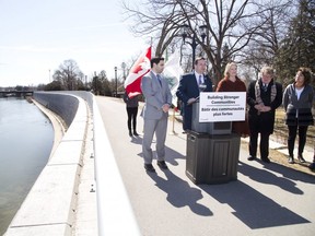 MP Marco Mendicino, parliamentary secretary to Minister of Infrastructure and Communities Francois-Philippe Champagne, announces $10M in funding for the West London Dike in London, Ont. on Wednesday. He was joined by Peter Fragiskatos (MP for London North Centre) on the left,  Kate Young (MP for London West), London Mayor Ed Holder and ward 9 councillor Anna Hopkins. (Derek Ruttan/The London Free Press)