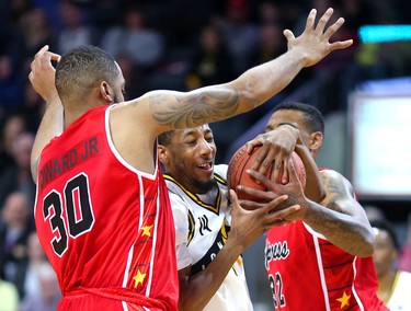 Lightning's Marcus Capers runs into heavy traffic between Windsor's Juwan Howard Jr and Angelo Griffis during their final game of the season at Budweiser Gardens in London, Ont. The game meant nothing to either team as the Lightning had clinched first in the division while Windsor is out of the playoff picture. Photograph taken on Sunday March 31, 2019.  Mike Hensen/The London Free Press/Postmedia Network