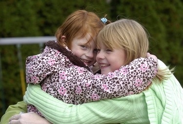 Olivia Vander Schelde 5 and her big sister Holland 8 share a hug. (2010 File photo)