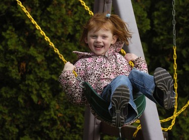 Five-year-old Olivia Vander Schelde enjoys the swing in the backyard of the family home. (2010 File photo)