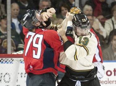 Windsor Spitfires winger Ty Bilcke, left, and London Knights winger Adam Restoule, right, drop the gloves and trade punches early in the first period of their OHL hockey game at Budweiser Gardens in London on Friday October 5, 2012. CRAIG GLOVER The London Free Press / QMI AGENCY