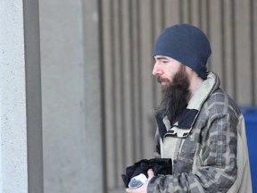 Howard Milne leaves the London courthouse Friday after being released on bail. Milne, 33, was arrested Thursday and charged with multiple child pornography-related offences. (DALE CARRUTHERS, The London Free Press)