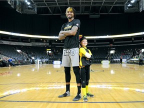 London Lightning forward Maurice Bolden and junior mascot Joey Murray, a.k.a. Flash Lite, share the court before a home game at Budweiser Gardens where both try their hardest to entertain fans. Murray, 9, is taking his energy-building abilities a step further this year - he recently became the Children's Miracle Network champion child representing Children's Hospital at London Health Sciences Centre, where he spent time recovering from cancer. Photo taken in London Ont. Feb. 7, 2019. (CHRIS MONTANINI, Postmedia News)