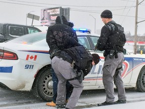 Members of the London police emergency response unit arrested Michael Gordon Tuesday morning at Wonderland and Southdale roads. Gordon, 38, is charged in connection with an armed robbery at a Florence Street home on Feb. 25. Photo shot on March 5, 2019. (DALE CARRUTHERS / THE LONDON FREE PRESS)