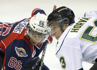 London Knights forward Bo Horvat and Windsor Spitfires forward Josh Ho-Sang keep their eyes on the puck as they face off during their OHL hockey game at Budwesier Gardens in London on Friday October 4, 2013. CRAIG GLOVER The London Free Press / QMI AGENCY