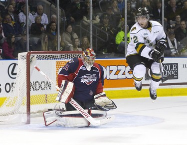 London Knights forward Aaron Berisha jumps to let the puck through while attempting to screen Windsor Spitfires goaltender Brendan Johnston, who saved the shot, during their OHL junior hockey regular season game at Budweiser Gardens in London, Ontario on Sunday December 28, 2014.  Windsor won the game 5-4 in a shootout. CRAIG GLOVER/The London Free Press/QMI Agency