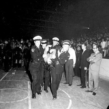 Police wrestle with teenagers at a Rolling Stones concert in London on April 27, 1965. (Western Archives, The London Free Press)