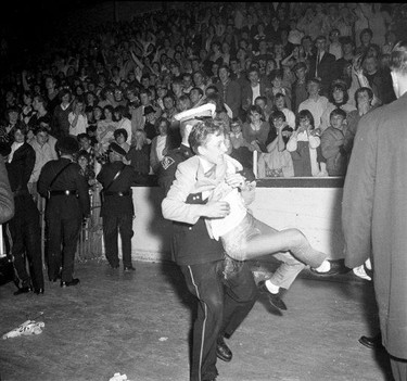 Police wrestle with teenagers at a Rolling Stones concert in London, April 27, 1965. (Western Archives, The London Free Press)