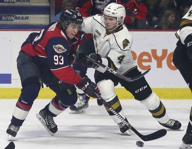 Jean-Luc Foudy, left, of the Windsor Spitfires and William Lochead of the London Knights battle for the puck during game 3 of their playoff series at the WFCU Centre in Windsor, ON.  (DAN JANISSE/The Windsor Star)