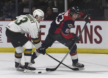 Adam Boqvist, left, of the London Knights and Jean-Luc Foudy of the Windsor Spitfires battle for the puck during game 3 of their playoff series at the WFCU Centre in Windsor, ON.  (DAN JANISSE/The Windsor Star)