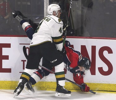 William Lochead, left, of the London Knights collides with Jean-Luc Foudy of the Windsor Spitfires during game 4 of their playoff series on Thursday, March 28, 2019 at the WFCU Centre in Windsor, ON. (DAN JANISSE/The Windsor Star)